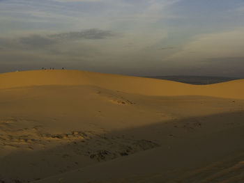 Scenic view of desert against sky during sunset