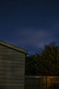 Low angle view of trees against sky at night