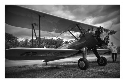 Airplane on runway against sky