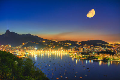 Scenic view of lake against sky at night