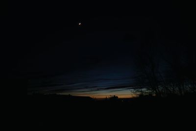 Scenic view of silhouette landscape against sky at night