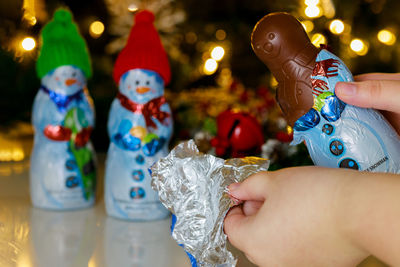 Midsection of woman holding christmas decorations