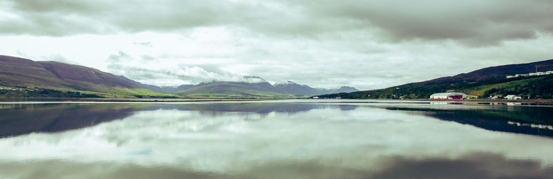 Scenic view of lake and mountains against sky