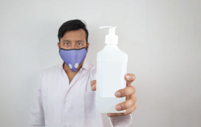 Portrait of man standing against white background