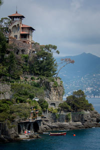 Building by sea against sky