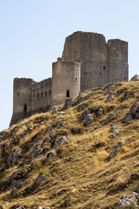 Low angle view of historical building against clear sky in rocca calascio