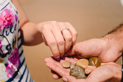 Cropped image of couple holding stones