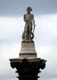 Low angle view of statue against cloudy sky