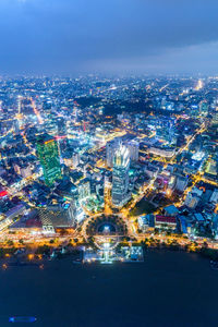 Aerial view of city lit up at night