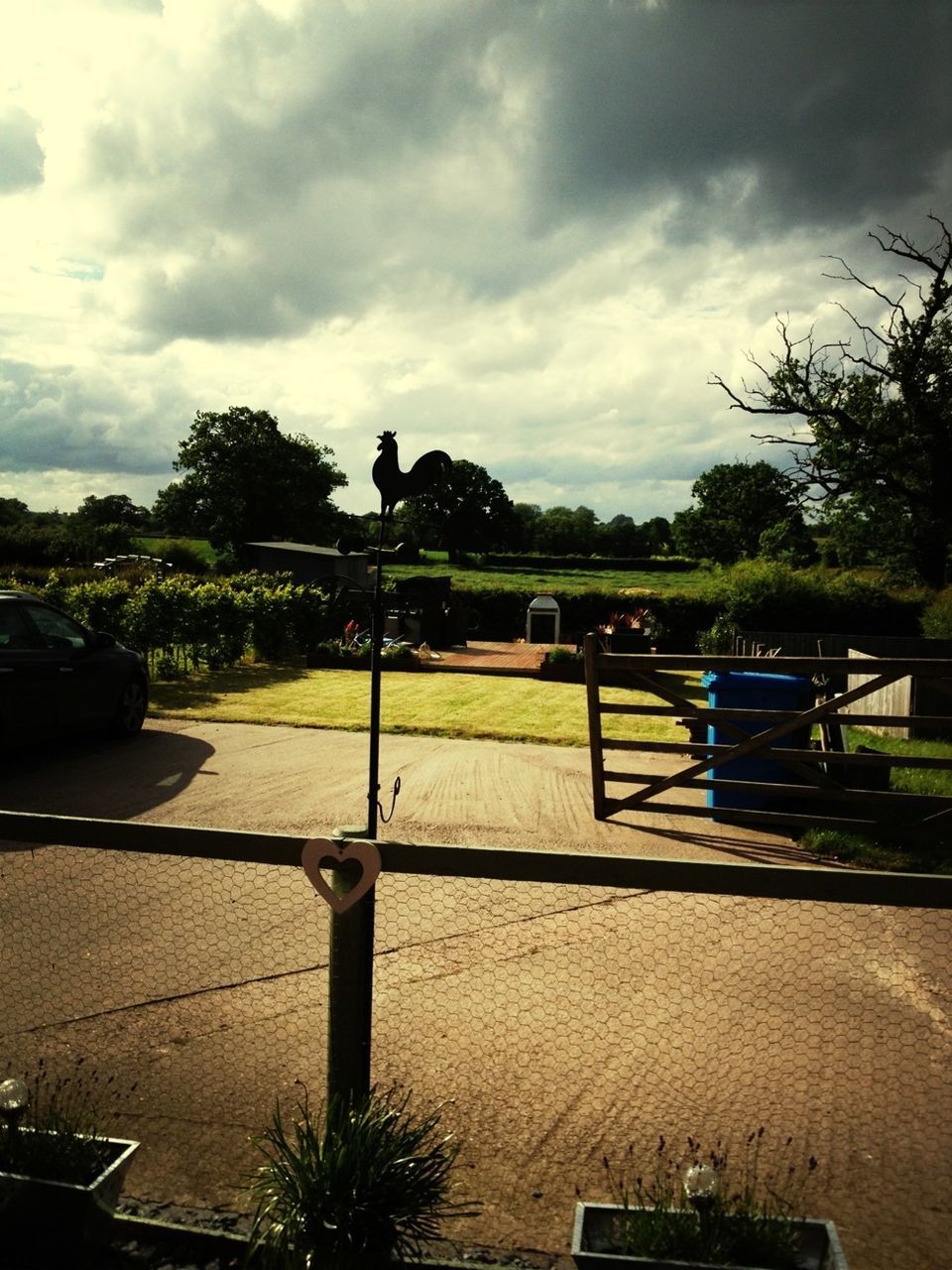 tree, sky, cloud - sky, empty, absence, cloud, grass, cloudy, tranquility, bench, tranquil scene, nature, chair, park - man made space, seat, field, growth, outdoors, sunlight, landscape