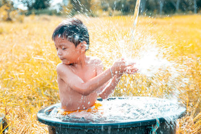 Shirtless boy in water