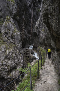 Rear view of man walking on rocks