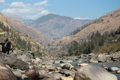 Scenic view of river and mountains against sky