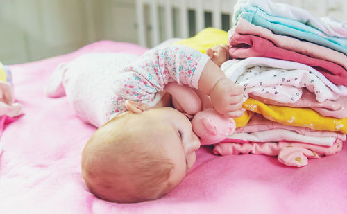 Baby boy lying on bed at home