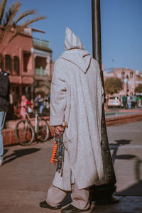 Low section of woman standing on street