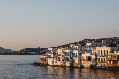 Sunset over the colourful old seaside houses in little venice, mykonos, greece.