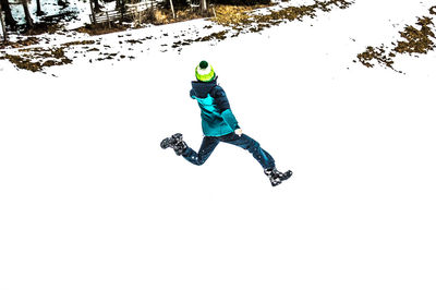 Full length of man climbing on snow