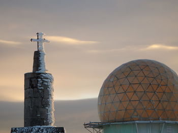 Close-up of cross against sky during sunset