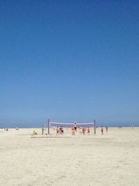 Scenic view of beach against blue sky