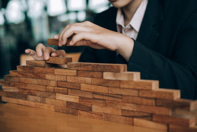 Rear view of man playing on table