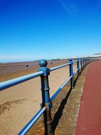 View of trees against clear blue sky