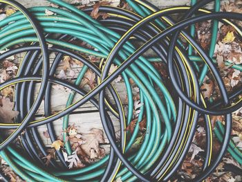 High angle view of hoses and leaves on table