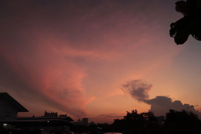 Low angle view of silhouette buildings against sky during sunset