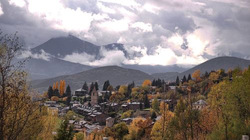 Panoramic view of trees and buildings against sky