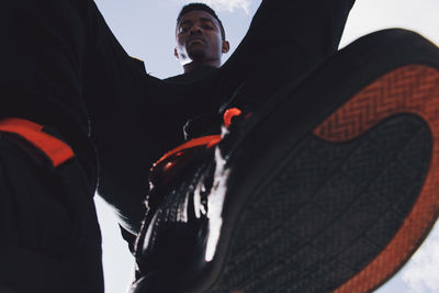 Low angle view of man looking at camera