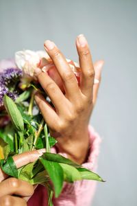Black woman holding flower bouquet