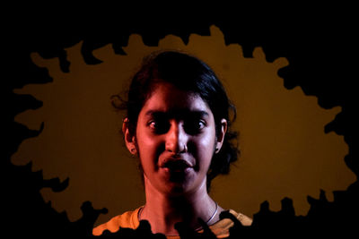 Portrait of young woman against wall