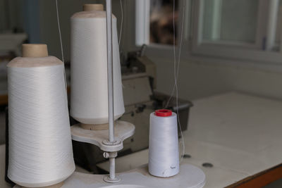 Close-up of thread on table at home