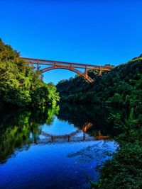 Arch bridge over river against sky