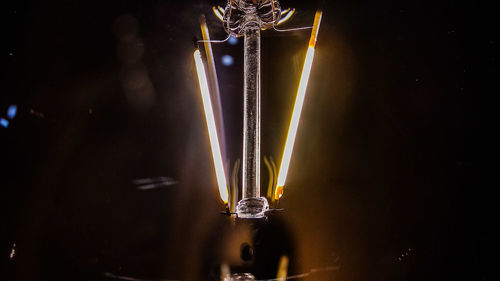 Close-up of illuminated lighting equipment at night