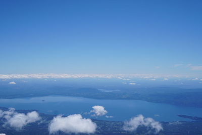 Aerial view of sea against clear blue sky