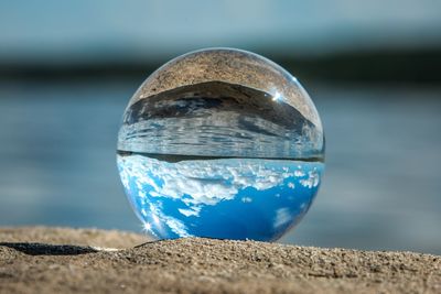 Close-up of crystal ball on rock