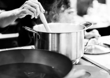 Midsection of man preparing food in kitchen