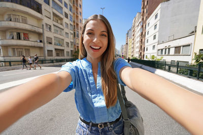 Woman with stylish wears takes self portrait on minhocao highway on sunday in sao paulo, brazil