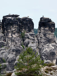 Low angle view of rock formations against sky