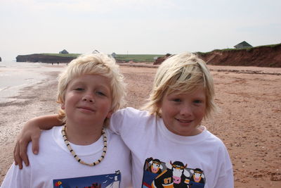 Portrait of brothers standing at beach