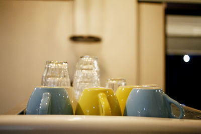 Close-up of mug and glass on table