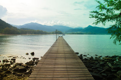 Pier over lake against sky