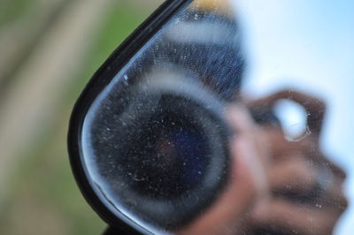 Close-up portrait of woman with reflection of camera