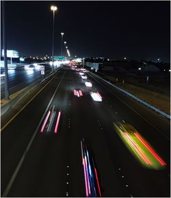 High angle view of light trails on road at night