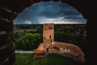 Old ruins of building against cloudy sky