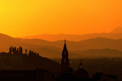 Silhouette church against sky during sunrise