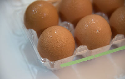 High angle view of brown eggs in tray on table