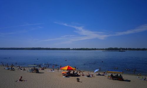 Scenic view of beach against blue sky