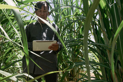 Portrait of woman holding plants