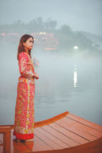 Asian woman wearing cheongsam traditional red dress on chinese new year travel.